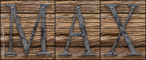 Three metallic letters on old wood generating the name MAX