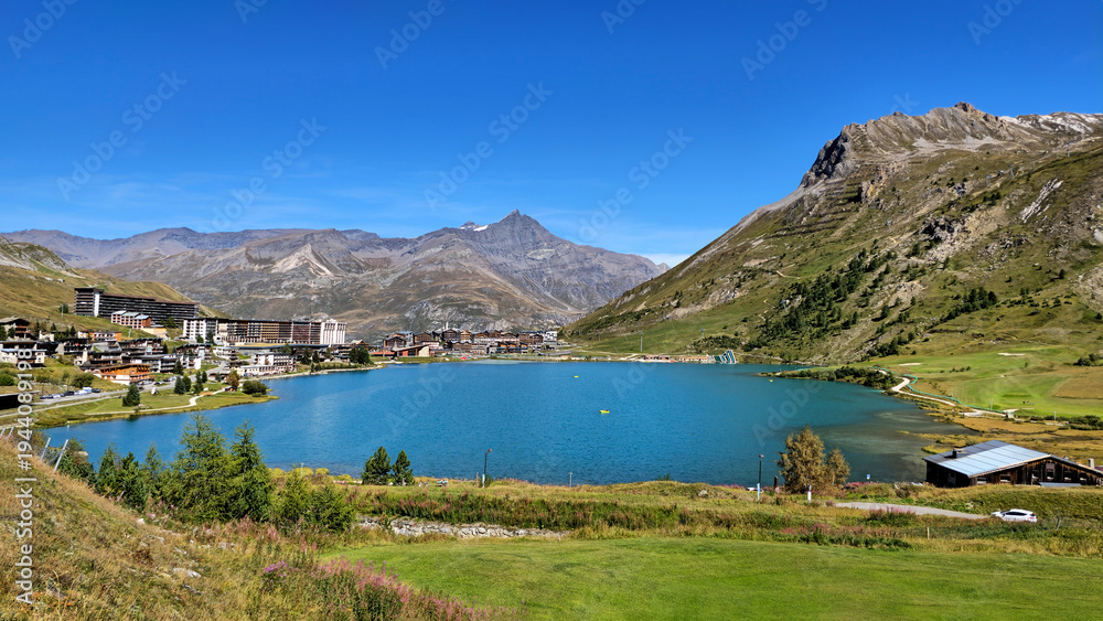 Fototapeta premium Panoramic view of the lake Lac de Tignes and the village in the French Alps valley, Savoie, France, Europe.