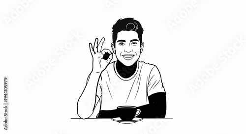 A smiling young man gives an okay sign while sitting at a table with a cup of coffee