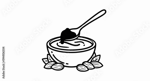 A spoonful of creamy spread is lifted from a bowl surrounded by almonds