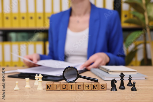 Photos In a bright office space, a student sits focused with notes and exam papers scattered around