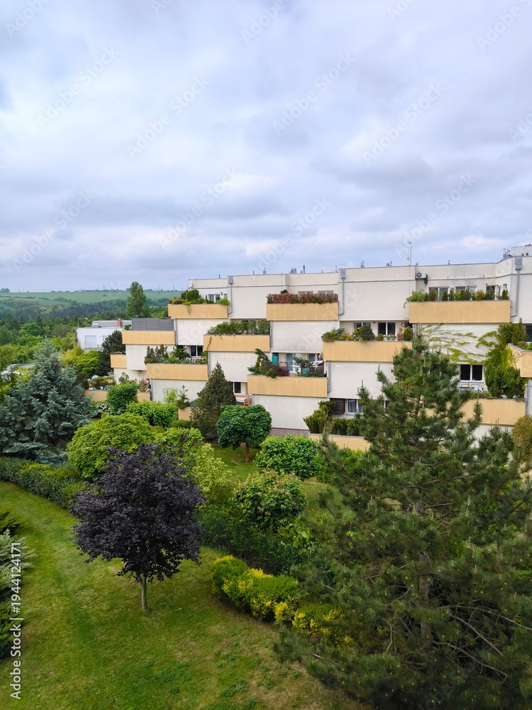 Obraz premium Modern terraced residential buildings with green gardens in Prague suburb, Czech Republic