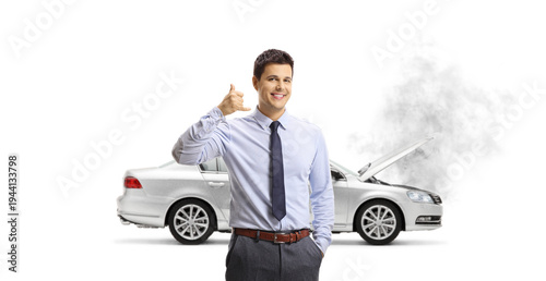 Billede på lærred Young businessman gesturing call me in front of a broken down car