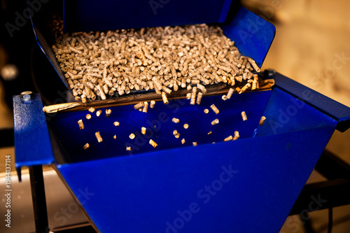 Pellet production in a factory. Heating a house with pellets. Pellet manufacturing process and its storage.
