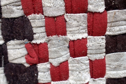 Colorful woven fabric mat. Traditional texture, handcraft, homemade, textile background.
Close up view of the pattern and texture of teh doormats fabric.