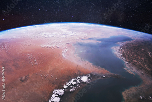 Cinematic satellite view of the Strait of Hormuz at night. Features glowing city lights of Iran, Oman, and UAE. Conceptual image for global energy trade, Middle East geopolitics, and maritime security