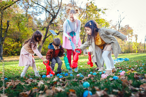 Female animator playing with a group of children at an outdoor birthday party.