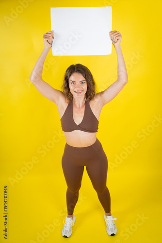 Fitness woman holding blank sign above head