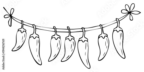 Hand drawn chili peppers strung on a line with a bow for decoration