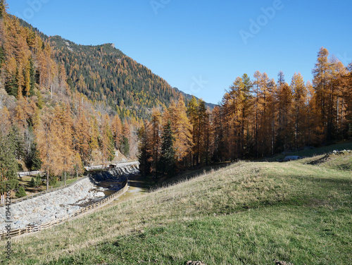 Autumn in the Alps. Chardonney, a hamlet of Champorcher, Aosta Valley, Alps, Italy.  Along the river.