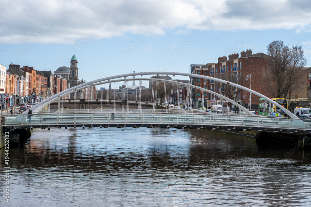 Naklejka premium Modern bridge with River Liffey waterfront in Dublin