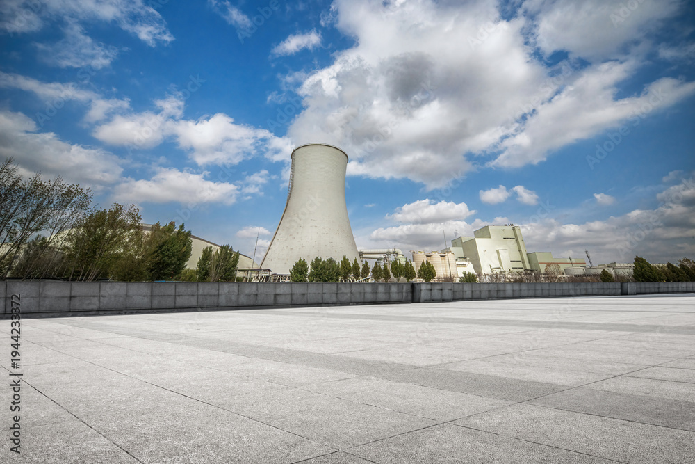 Obraz premium Majestic Industrial Landscape with Cooling Tower and Clear Blue Skies