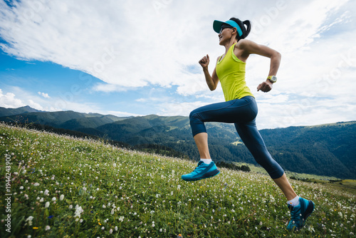 Trail runner running on the high altitude grassland mountains