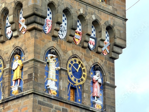 The ornate clock tower of Cardiff Castle stands against a dramatic sky in the capital city of Wales.