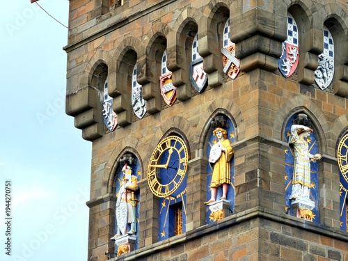 The ornate clock tower of Cardiff Castle stands against a dramatic sky in the capital city of Wales.