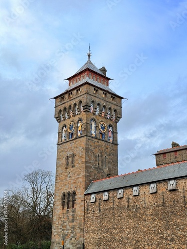 The ornate clock tower of Cardiff Castle stands against a dramatic sky in the capital city of Wales.