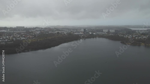 Wallpaper Mural Aerial drone footage showing a suburban area during gloomy midday conditions. The scene features residential houses, streets, and surrounding infrastructure under overcast skies and diffused daylight, Torontodigital.ca