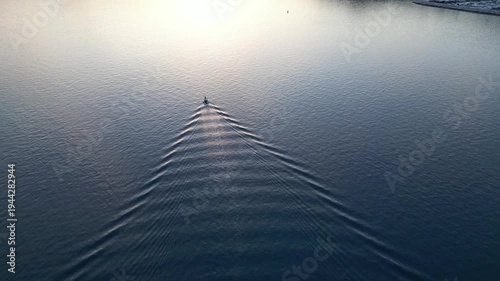 Boat sailing on the bay at sunset