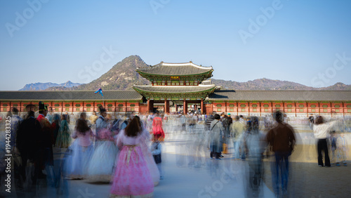 Tourists in Hanbok at Heungryemun Gate of Gyeongbokgung Palace with Motion Blur (Colors of Tradition) in Seoul, South Korea