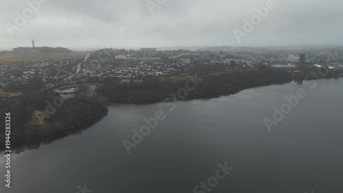 Wallpaper Mural Aerial drone footage showing a suburban area during gloomy midday conditions. The scene features residential houses, streets, and surrounding infrastructure under overcast skies and diffused daylight, Torontodigital.ca
