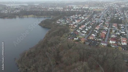 Wallpaper Mural Aerial drone footage showing a suburban area during gloomy midday conditions. The scene features residential houses, streets, and surrounding infrastructure under overcast skies and diffused daylight, Torontodigital.ca