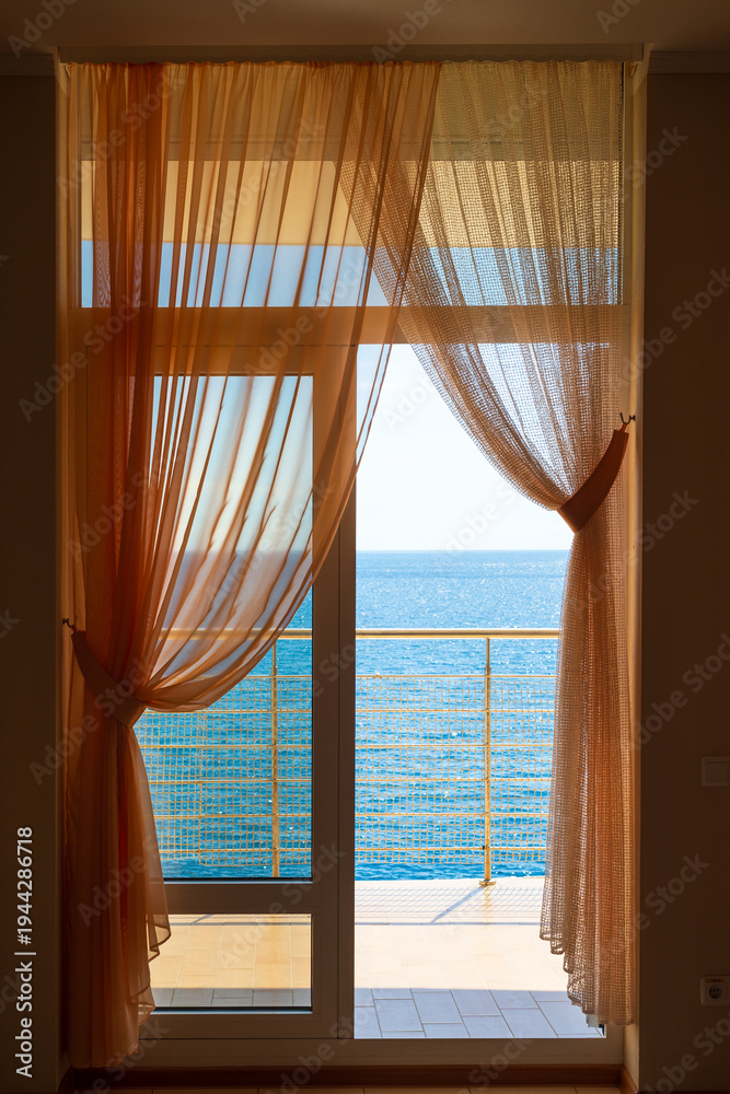 Obraz premium Luxury resort room door to the breezy waterfront terrace with ocean view, Mediterranean sea, Europe