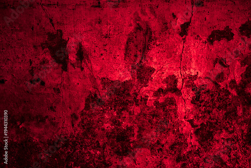 An aged red grunge background featuring a dark textured wall design with a rusty vintage paint pattern for a rough artistic backdrop