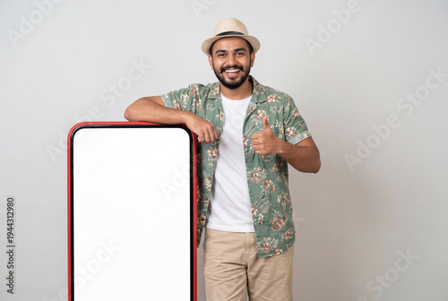 young indian man standing with big mobile screen on isolated background