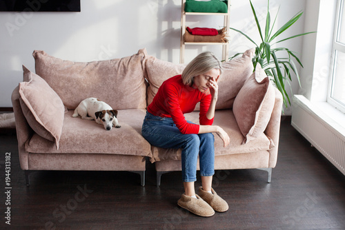 Billede på lærred Adult Upset middle age woman in red blouse getting bored at home, sitting in liv