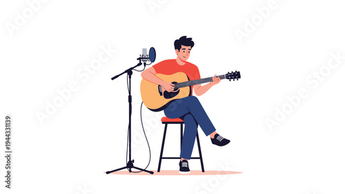 Talented male musician sitting on a stool and playing an acoustic guitar while recording vocals with a professional microphone setup.