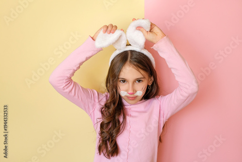 Photography A beautiful curly-haired girl with a painted face in the guise of a bunny adjust