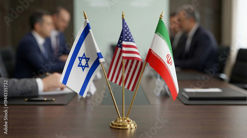 Flags of Israel, United States and Iran displayed on a table during a diplomatic meeting with blurred participants in background, concept of peace agreements, diplomacy, Middle East conflict