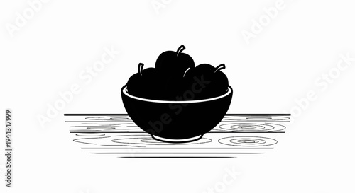 Black silhouette of a bowl of fruit on a wooden surface