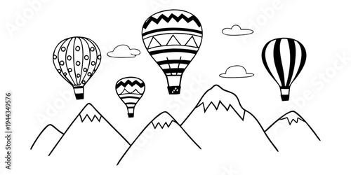 Hot air balloons floating above a mountain range with clouds in the sky