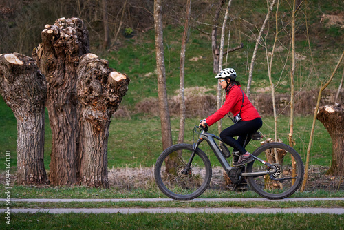 Active senior woman cycling...