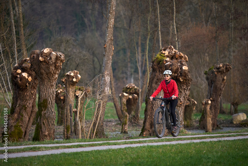 Active senior woman cycling...