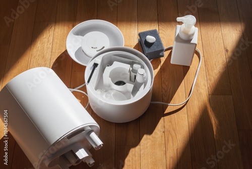 Fotografía Household maintenance cleaning humidifier components on wooden floor