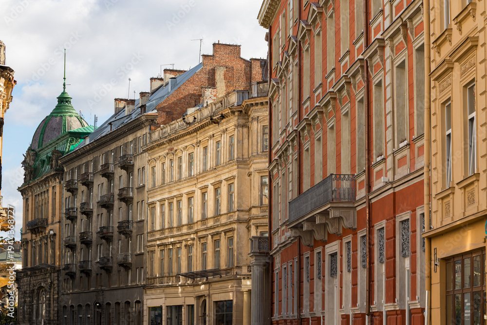 Obraz premium Historic European architecture with ornate facades and a green domed building