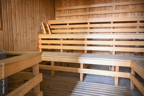 Sauna interior featuring wooden benches and walls, creating a clean relaxing environment