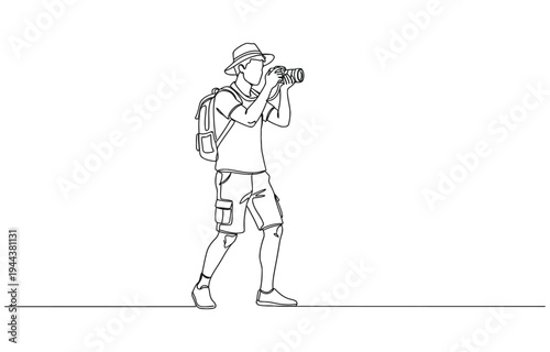 Male photographer with camera taking pictures outdoors.
