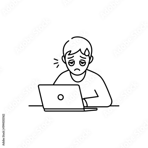 Sad young man working on laptop with a worried expression  