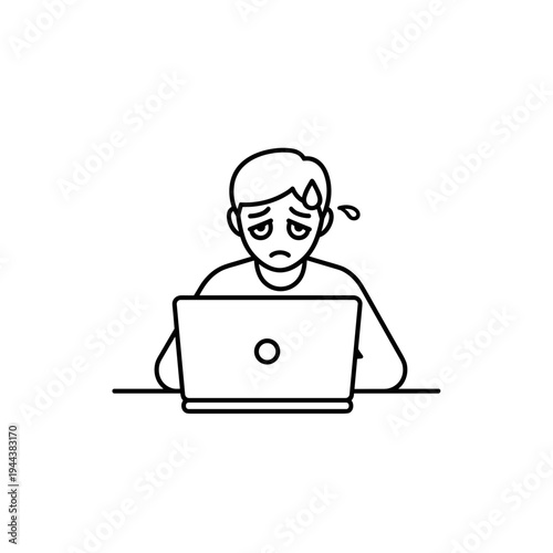 Young man looking stressed while working on laptop at desk  