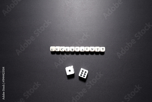 Tablou pe pânză Uncertainty word above dice representing financial instability, unpredictable outcomes, and strategic risk
