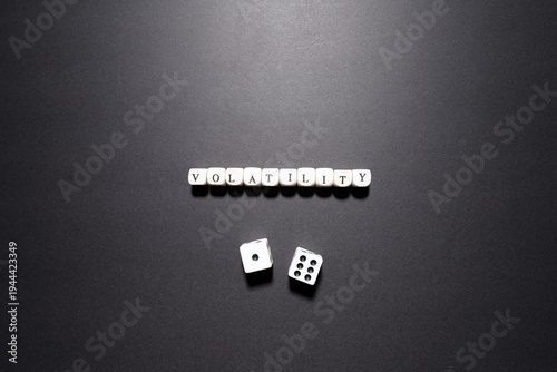 Foto Volatility word above dice symbolizing market fluctuations, financial instability, and unpredictable risk