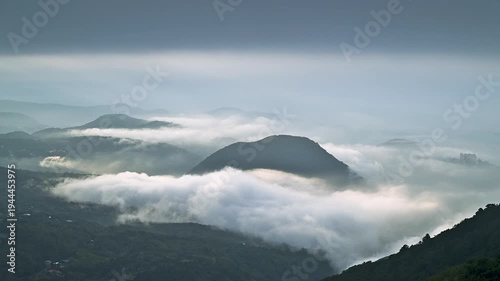 A breathtaking morning view of the cloud sea rolling over the peaks of Datun Mountain in Beitou, Taipei, during the spring season.