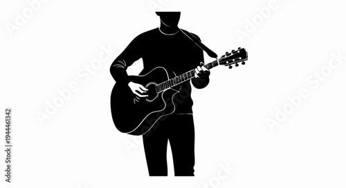 Silhouette of a man playing acoustic guitar.