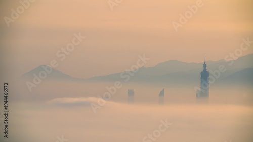 A scenic view of Taipei building rising above a sea of clouds during a misty sunrise, captured from Datong Mountain in New Taipei City, Taiwan.