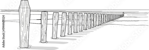 A line of wooden posts extends into the distance, bordering a calm body of water