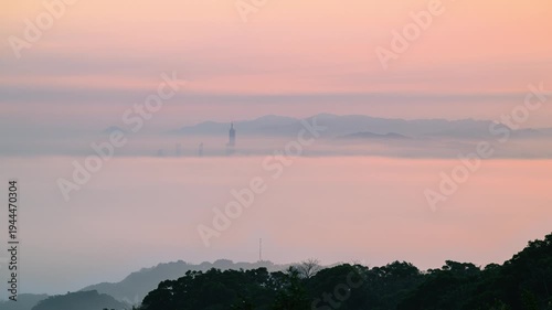 A breathtaking sunrise view of Taipei 101 emerging from a sea of clouds, seen from Datong Mountain in New Taipei City, Taiwan.