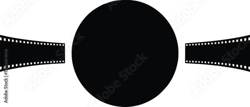 Classic film reel passing over a large black circular film projector lens.